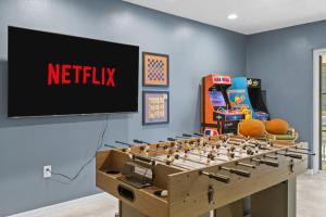 a game room with a netflix sign on a wall at Poolside Fun Games Perfect Family Escape in Largo +61 photos