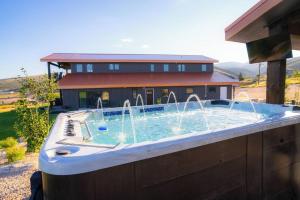 a large pool with fountains in front of a house at Sleeps 40, Pool House in Garden City