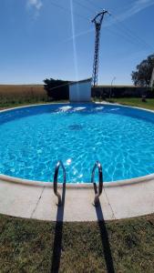 ein großer blauer Pool mit zwei Metallgriffen in der Unterkunft Casa rural villalta in Salvadiós