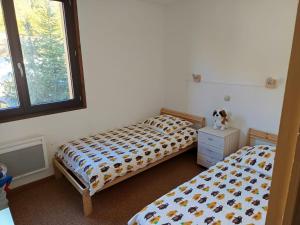Postel nebo postele na pokoji v ubytování Appartement 3 pièces au pied des pistes de la Colmiane