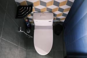 a bathroom with a white toilet in a room at MAI HOTAY Lakeside Highland Retreat Homestay in Ðức Lập +109 photos