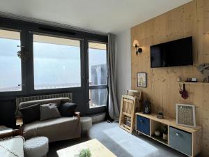 a living room with a couch and a large window at Résidence Le Tourmalet - maeva Home - Appartement 2 pièces 4 personnes - Confort MAE-1861 in La Mongie
