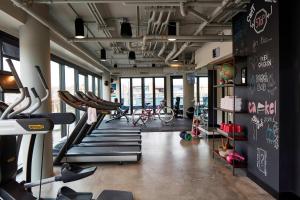 a gym with a bunch of cardio equipment in it at MOXY Denver Cherry Creek in Denver