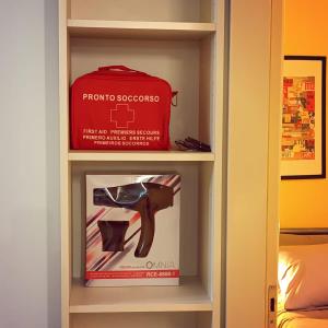 a book shelf with a red suitcase and shoes at Stelios apartment 2 in Chios +9 photos