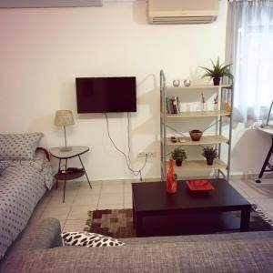 a living room with a couch and a table at Stelios apartment 2 in Chios