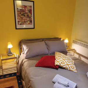 a bed with two pillows on it in a room at Stelios apartment 2 in Chios