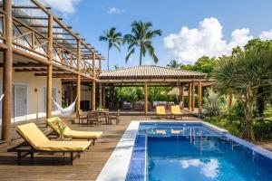 a house with a swimming pool and a patio at Villa Alema Luxury Beach House in Marau