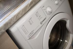a washing machine with a label on it at Artemis Seaside House, With Sea View in Kalamaki Heraklion