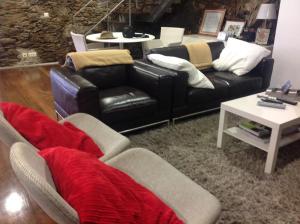 a living room with a couch and a table at Quinta dos Castanheiros - Turismo Rural in Negreda