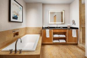 a bathroom with a tub and a sink at The Westin St. Louis in Saint Louis +43 photos