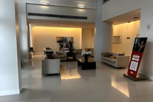 a living room with couches and chairs in a building at Saint Moritz com vista espetacular de Brasilia in Brasilia