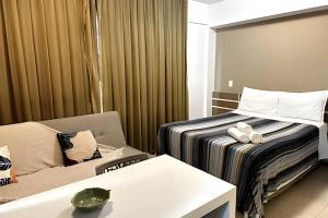 a hotel room with a bed and a chair at Saint Moritz com vista espetacular de Brasilia in Brasilia +62 photos