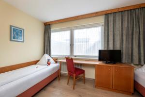 Televízia a/alebo spoločenská miestnosť v ubytovaní Bliem's Familienhotel