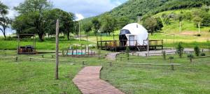 a playground with a tent in a field at El Eden Nature Resort in Siambón
