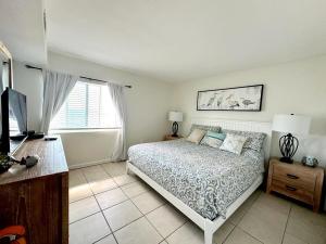 a bedroom with a bed and a television in it at Aqua Villa Condo 204 Beachfront in Fort Walton Beach