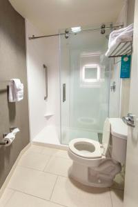 a bathroom with a toilet and a glass shower at SpringHill Suites Columbus Airport Gahanna in Gahanna