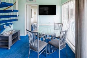 a dining room with a glass table and chairs at Plantation West #1348 in Gulf Shores