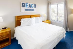 a bedroom with a large white bed and a window at Plantation West #1348 in Gulf Shores