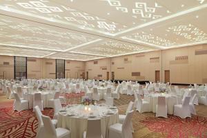 a large banquet hall with white tables and chairs at The Westin Desaru Coast Resort in Desaru +37 photos