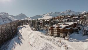 a ski lodge on top of a snow covered mountain at Le Strato in Courchevel