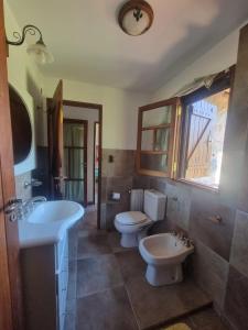 a bathroom with two toilets and a sink at Las Veronas in Villa de Las Rosas