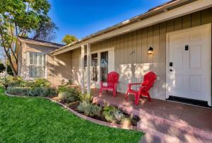two red chairs sitting on the front porch of a house at Peaceful Retreat in Anaheim-close to Disney in Anaheim