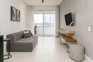 弗洛里亚诺波利斯WI-FI 200MB | Rooftop com Piscina e VistaMar #CA70的客厅里有一张沙发和一张桌子。