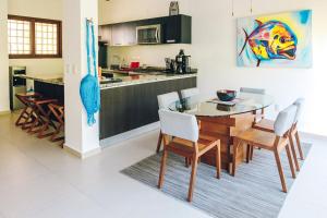 a kitchen and dining room with a table and chairs at Serene Jungle Villa -Steps from the Ocean in Akumal