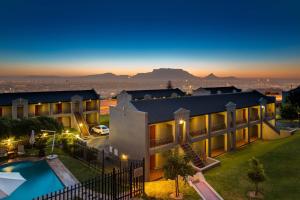an aerial view of a building with a swimming pool at Protea Hotel by Marriott Cape Town Tyger Valley in Bellville