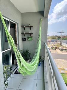 a hammock hanging from the side of a balcony at Apto Amplo e aconchegante px a praia! in São-José-do-Ribamar