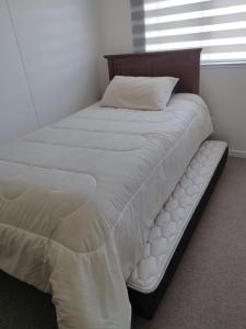 a bed in a bedroom with a pillow on it at Casa para 6 personas in Villarrica