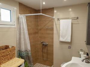 a bathroom with a shower and a sink at Maria's House, With Garden in Kalamaki Heraklion +18 photos