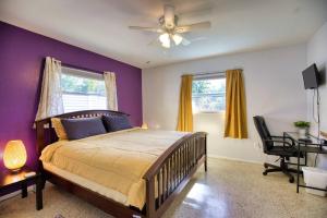 a bedroom with a bed and a ceiling fan at Stylish Retro Vibes Private Bbq & Beach Access in Sarasota