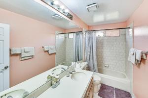 a bathroom with a tub and a sink at 13 Mi to Dtwn Riverside SoCal Family Home! in Corona +27 photos