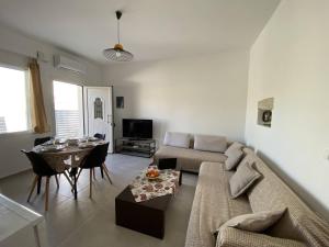 a living room with a couch and a table at Orphanos Apartment in Kamilari