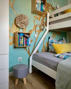 a childs bedroom with a bunk bed and a book shelf at FeWo Zur Wasserburg in Oelsnitz/Vogtland