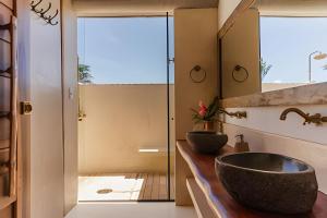 a bathroom with a sink and a mirror at Casa Morro da Luz Bahia in Ilha do Tatu +16 photos