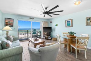 a living room with a table and chairs and a dining room at Pelican Isle 313 in Fort Walton Beach