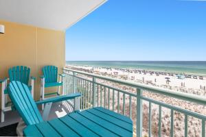 a balcony with blue chairs and the beach at Pelican Isle 313 in Fort Walton Beach