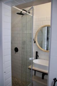 a bathroom with a sink and a mirror at Cozy Lounge - Visit Langebaan in Langebaan