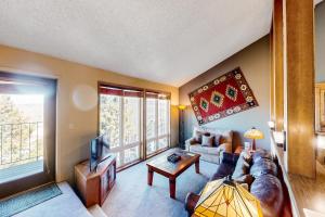 a living room with a couch and a tv at Mountainside 037 in Granby +69 photos