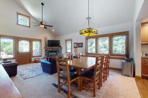 a dining room and living room with a table and chairs at Running Bear & Buffalo Run in the Rockies (Master Listing) in Estes Park