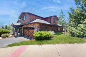a brown house with a garage at Running Bear & Buffalo Run in the Rockies (Master Listing) in Estes Park