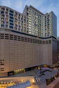 a large building with a courtyard in front of it at Marriott Executive Apartments Kuwait City in Kuwait