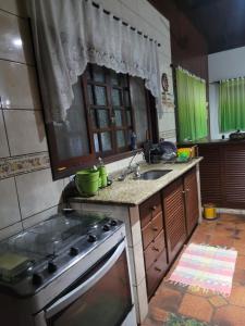 eine Küche mit Herd und Spüle in der Unterkunft Casa para Réveillon na praia in São Sebastião