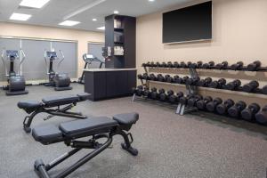 a gym with several exercise bikes and a television at TownePlace Suites by Marriott San Antonio Westover Hills in San Antonio