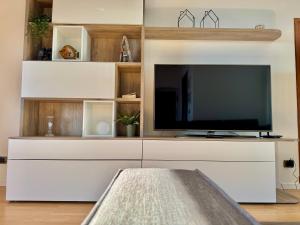 a large white entertainment center with a flat screen tv at Kiss of sea - Balzi Rossi & Baia Beniamin in Ventimiglia