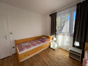 Ένα ή περισσότερα κρεβάτια σε δωμάτιο στο Apartmán Rita