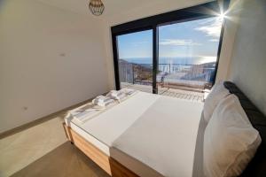 a bedroom with a bed and a large window at Villa Jelena with private pool - Lapcici in Budva +40 photos