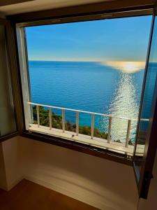 a window with a view of the ocean at Kiss of sea - Balzi Rossi & Baia Beniamin in Ventimiglia
